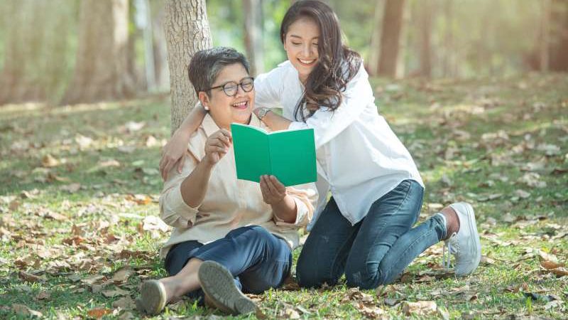elder-asian-mother-daughter-reading-book-woods-green-grass-lawn-concept-happy-family-life-family-relations-retirement-life-have-vacation-lifestyle-800
