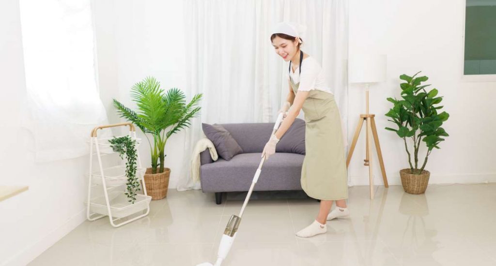 woman-cleaning-floor-with-vacuum-cleaner-1200