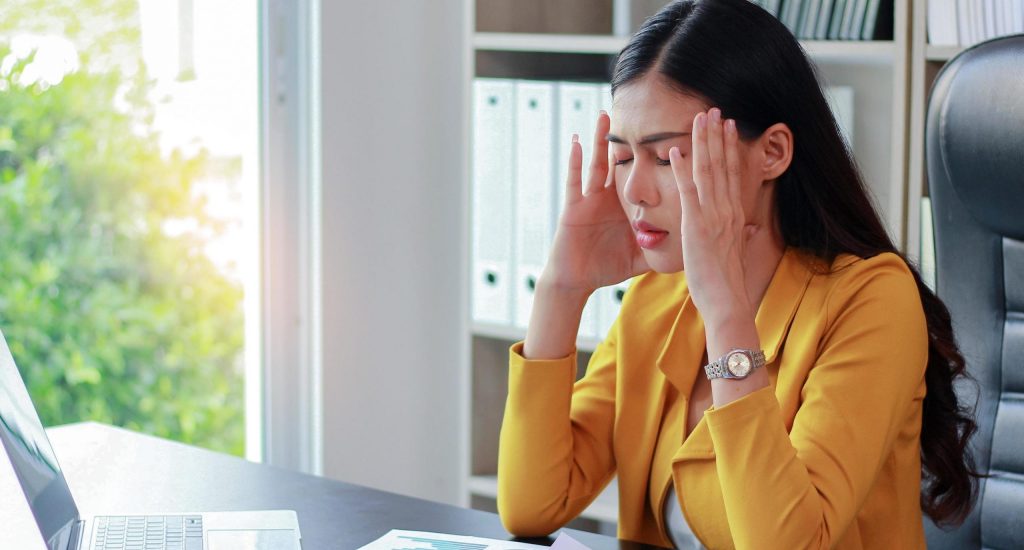 portrait-of-asian-woman-in-yellow-suit-sitting-in-the-office-thinking-about-marketing
